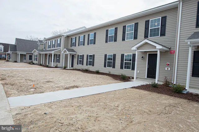 a view of a house with a large window and brick walls