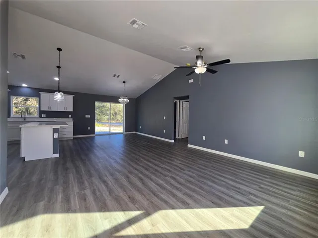a view of a kitchen with a sink and a living room view