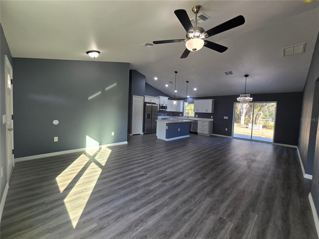 245 Locust Pass Lane Ocala, FL 34472 - Photo 12 of 41 a view of kitchen and hall with wooden floor
