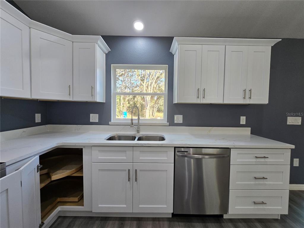 245 Locust Pass Lane Ocala, FL 34472 - Photo 17 of 41 a kitchen with cabinets appliances a sink and a window