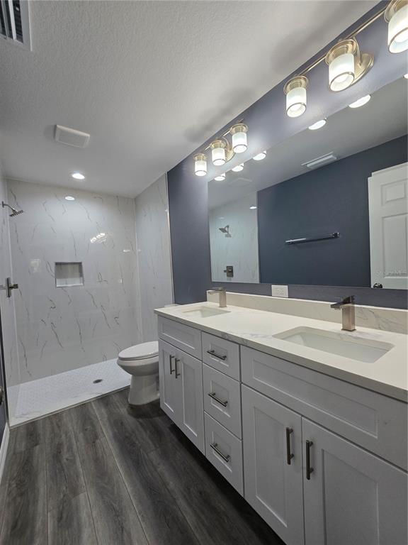 245 Locust Pass Lane Ocala, FL 34472 - Photo 23 of 41 a spacious bathroom with a double vanity sink a toilet and a large mirror