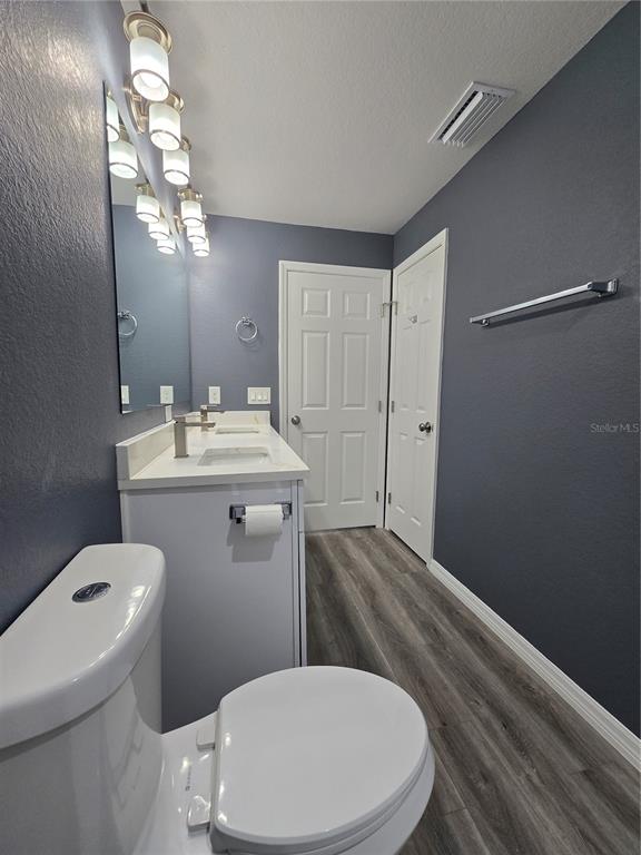 245 Locust Pass Lane Ocala, FL 34472 - Photo 24 of 41 a bathroom with a toilet a sink and mirror