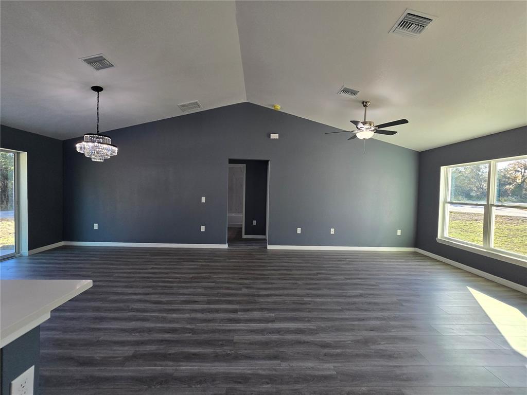 245 Locust Pass Lane Ocala, FL 34472 - Photo 29 of 41 a view of an empty room with a window and wooden floor