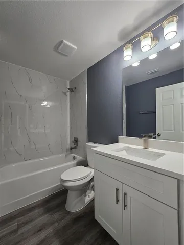 a bathroom with a sink toilet a mirror and shower