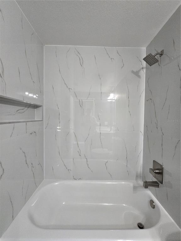 245 Locust Pass Lane Ocala, FL 34472 - Photo 35 of 41 a bathroom with a bathtub and a shower