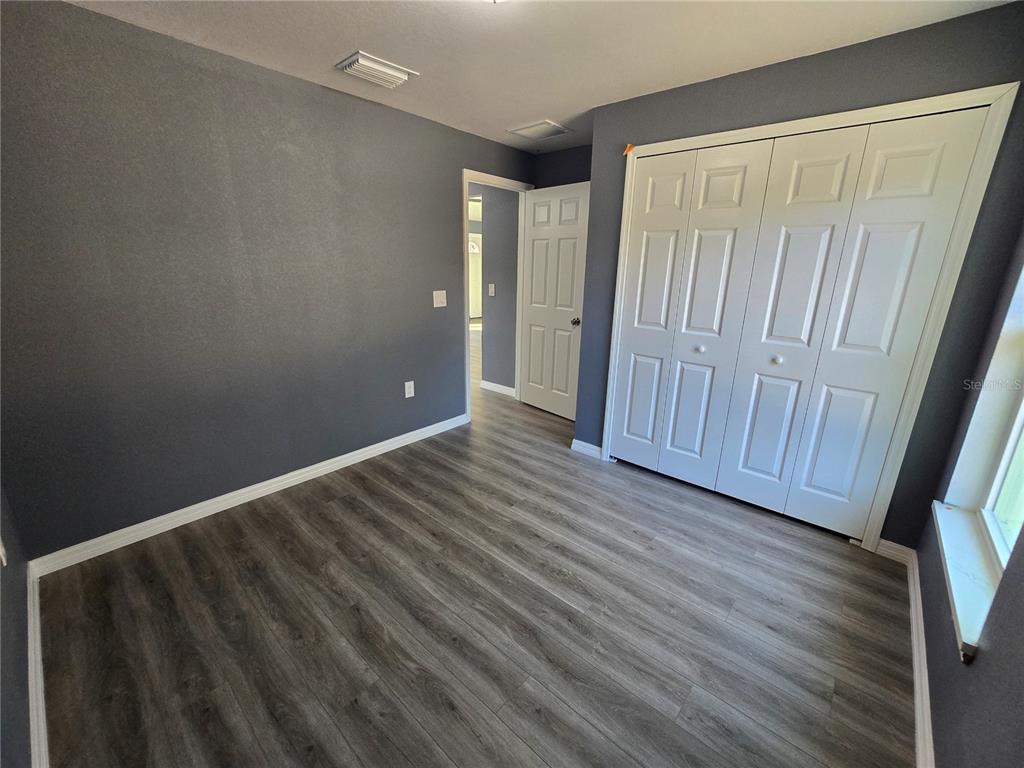 245 Locust Pass Lane Ocala, FL 34472 - Photo 37 of 41 a view of an empty room with wooden floor