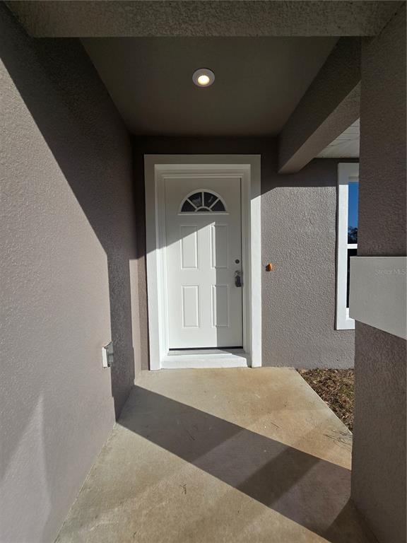 245 Locust Pass Lane Ocala, FL 34472 - Photo 10 of 41 a view of a hallway to a bedroom