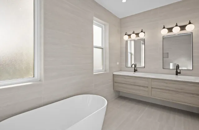 a bathroom with bathtub and window