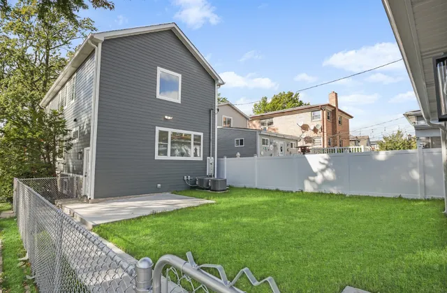 a view of a house with a yard and sitting area