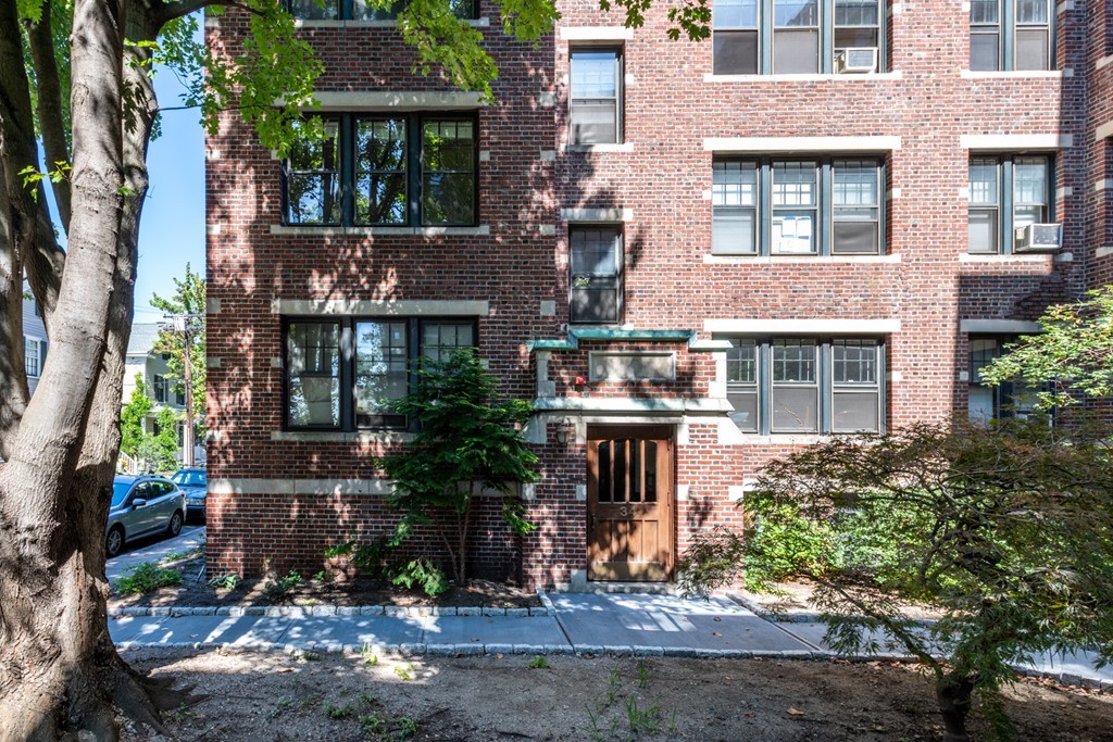 34 Ash Street, Unit 204 Cambridge, MA 02138 - Photo 8 of 10 a front view of a house with a yard