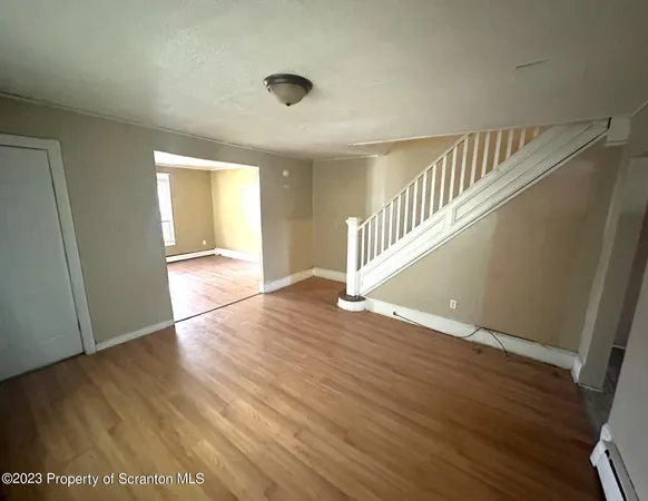 a view of an entryway with wooden floor