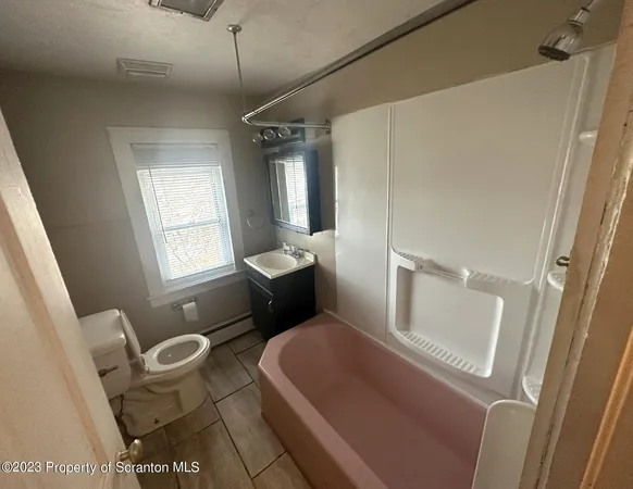 a bathroom with a toilet sink and tub