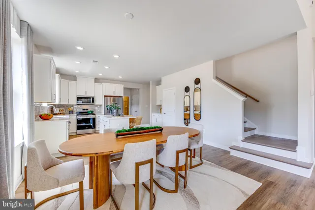 a dining room with furniture and wooden floor