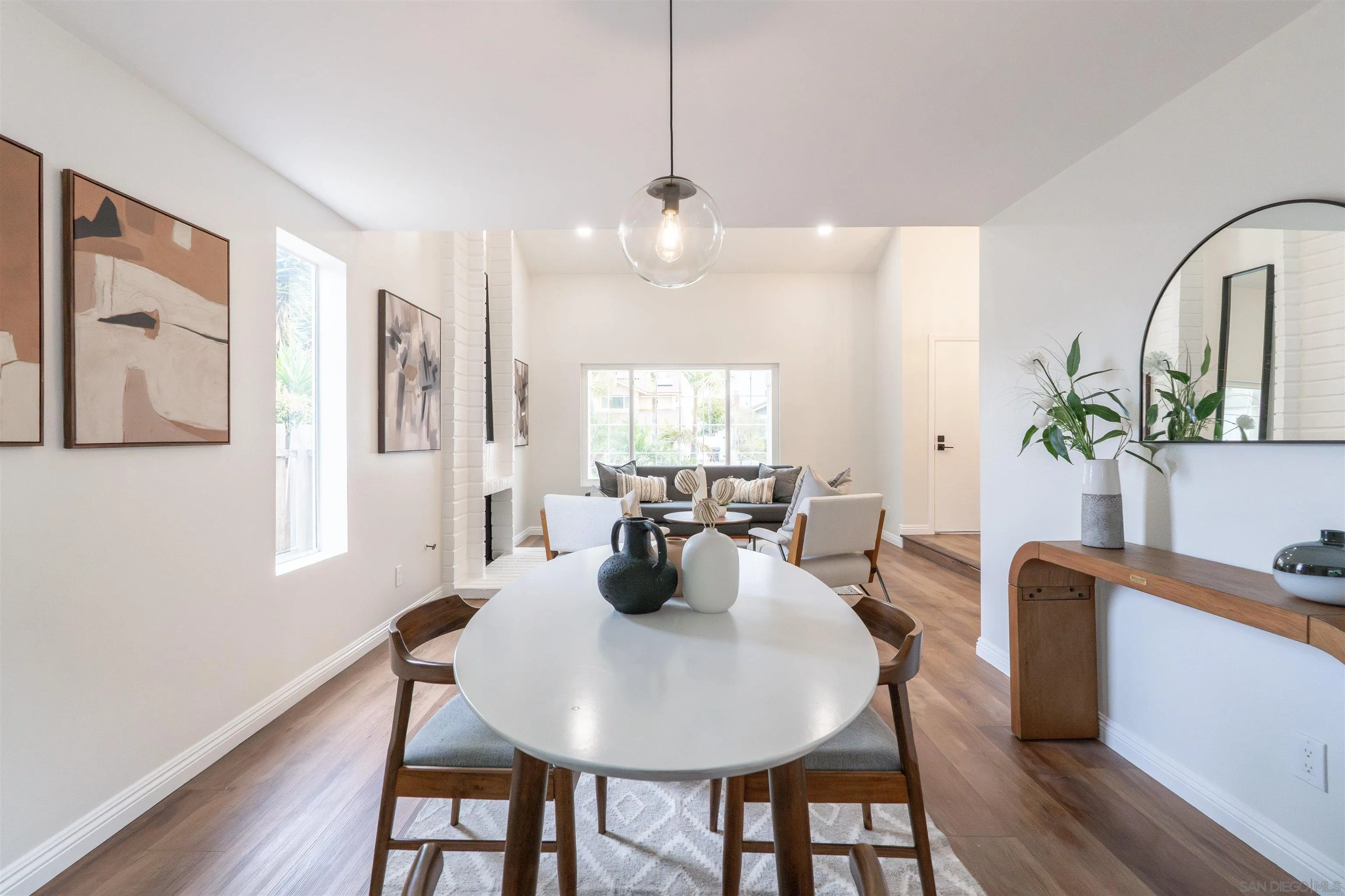 359 Compass Road Oceanside, CA 92054 - Photo 11 of 59 a dining room with furniture potted plants and wooden floor