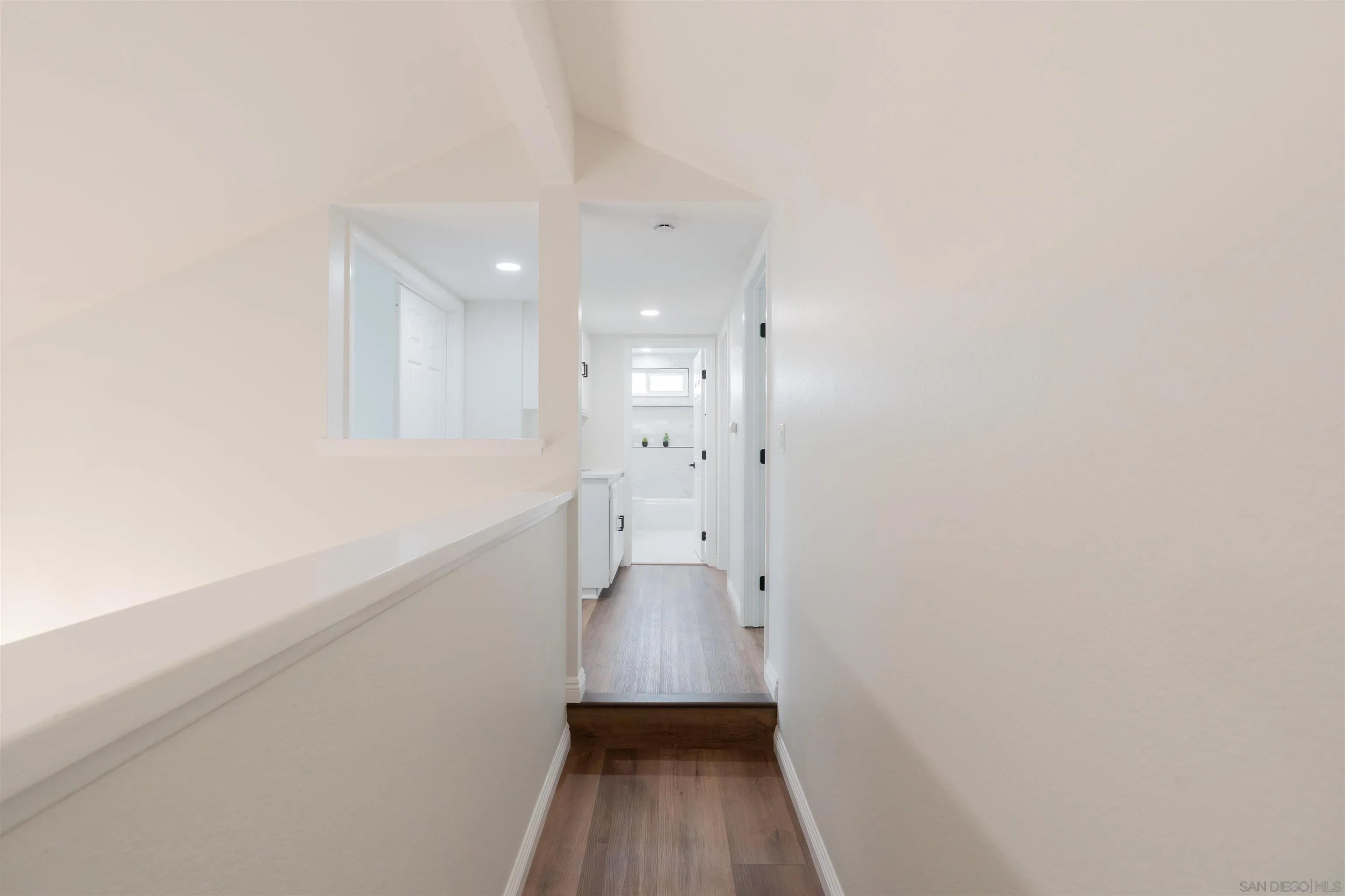 359 Compass Road Oceanside, CA 92054 - Photo 32 of 59 a view of a hallway with wooden floor and a window