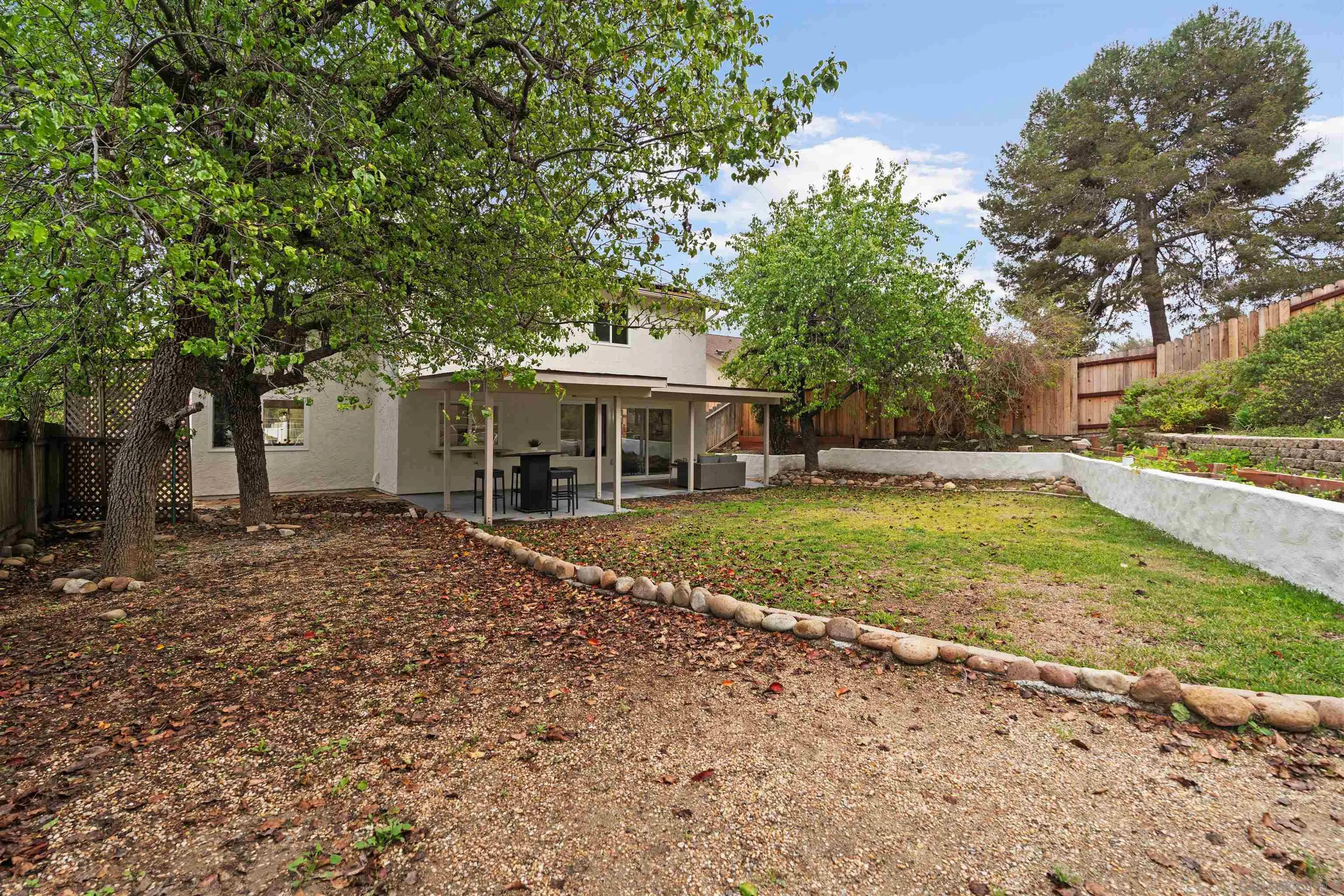 359 Compass Road Oceanside, CA 92054 - Photo 51 of 59 a front view of a house with a yard and trees