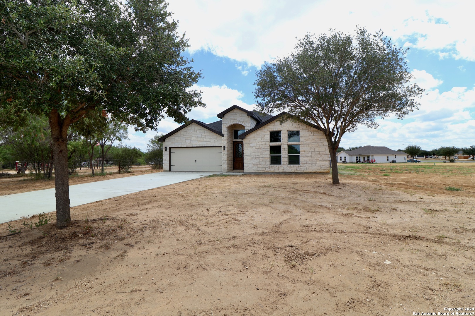 779 Fm 3175 Lytle, TX 78052 - Photo 1 of 1 a house with trees in front of it