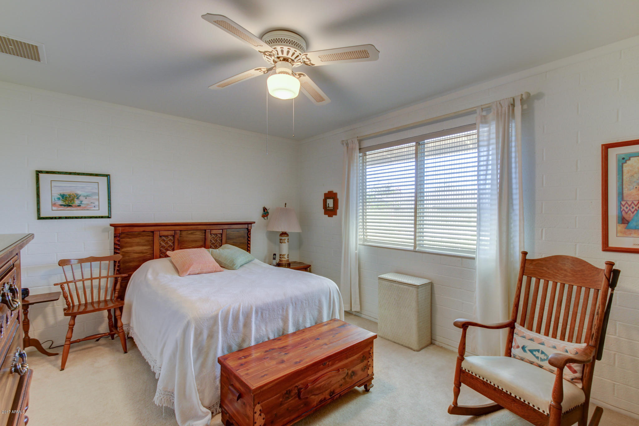 10008 West Riviera Drive Sun City, AZ 85351 - Photo 22 of 26 a bedroom with a bed chairs and a window