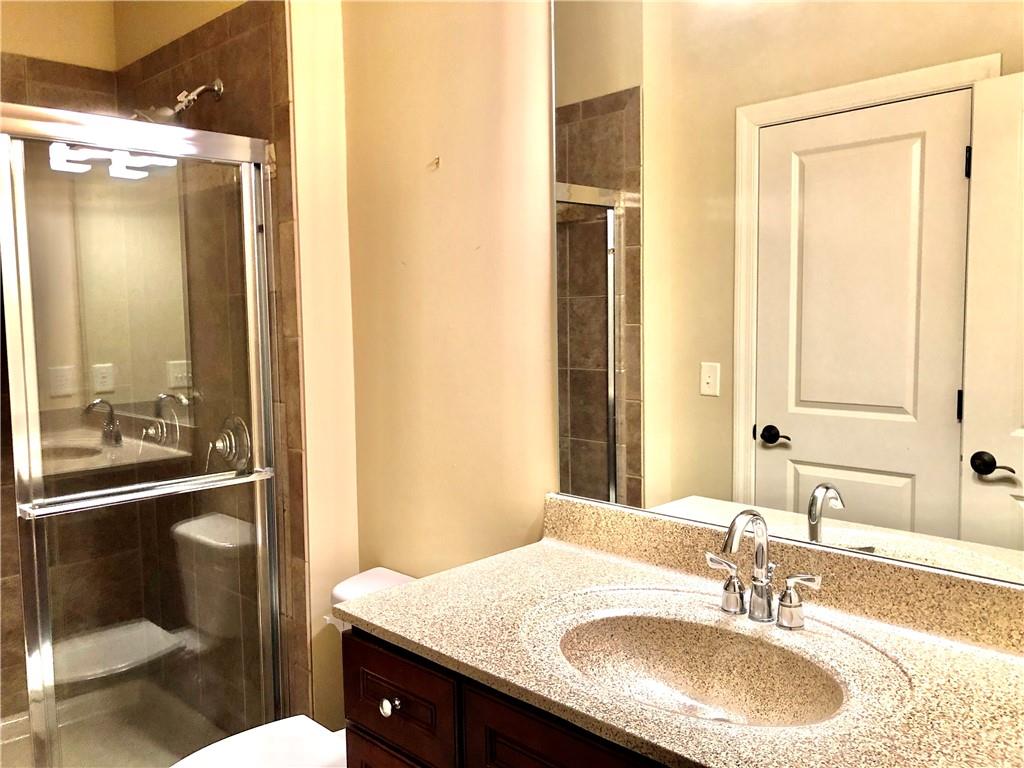 10575 Bent Tree View Duluth, GA 30097 - Photo 18 of 20 a bathroom with a granite countertop sink and a mirror