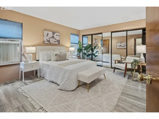 a bedroom with a large bed and a large window