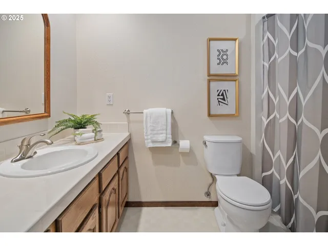 a bathroom with a sink vanity mirror and toilet