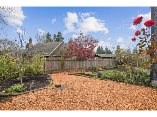 a backyard of a house with table and chairs