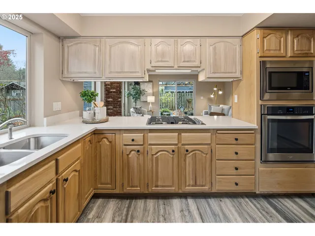 a kitchen with stainless steel appliances granite countertop a sink and cabinets