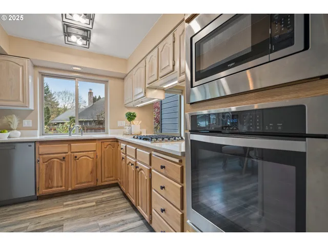 a kitchen with stainless steel appliances granite countertop a stove and cabinets