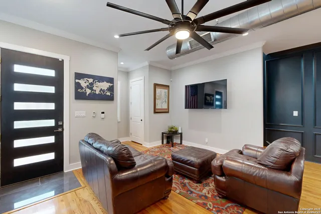 a living room with furniture ceiling fan and a rug