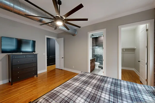 a bathroom with a granite countertop sink mirror vanity and toilet