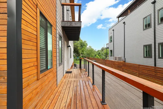 a view of balcony with wooden floor and fence