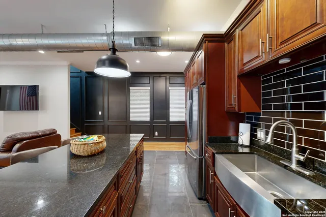 a living room with furniture kitchen view and a window