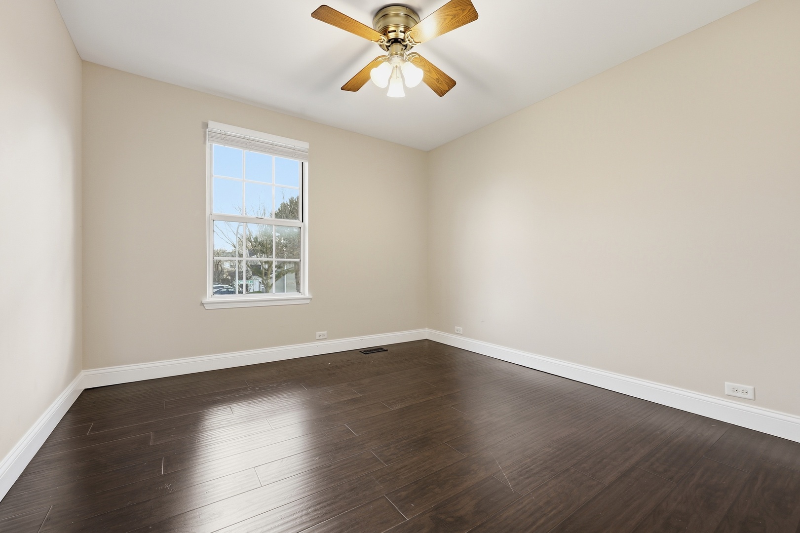 1780 Pebble Beach Circle Elgin, IL 60123 - Photo 14 of 21 an empty room with wooden floor chandelier fan and windows