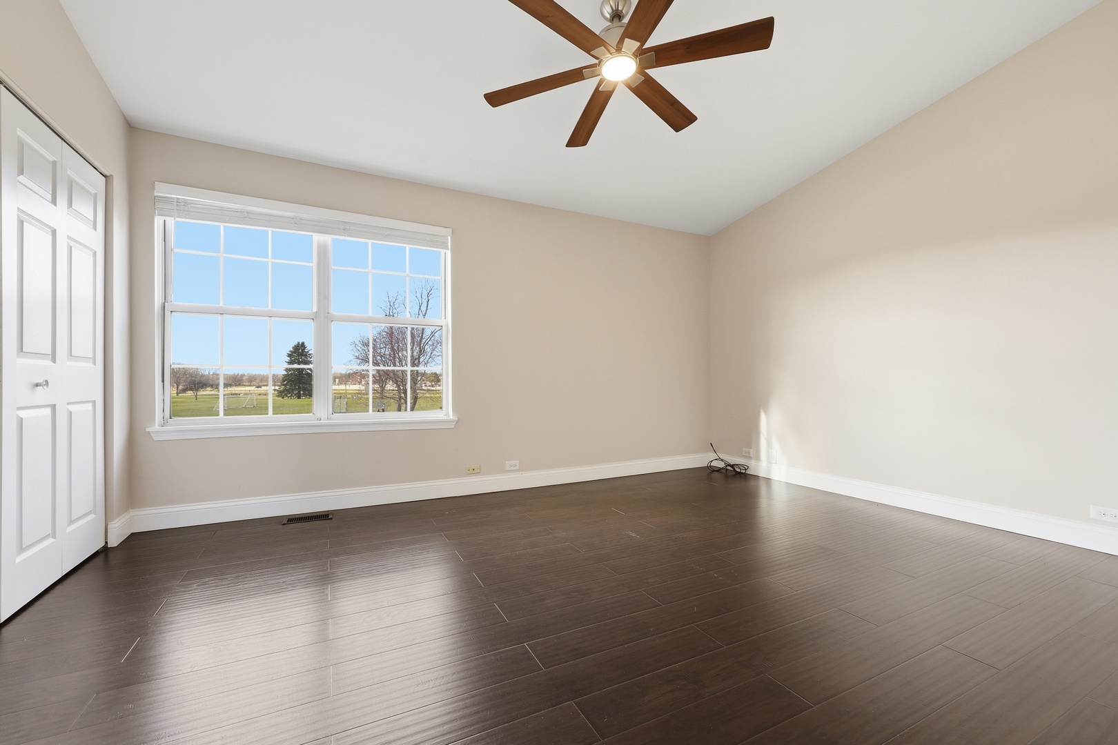 1780 Pebble Beach Circle Elgin, IL 60123 - Photo 15 of 21 an empty room with wooden floor fan and windows