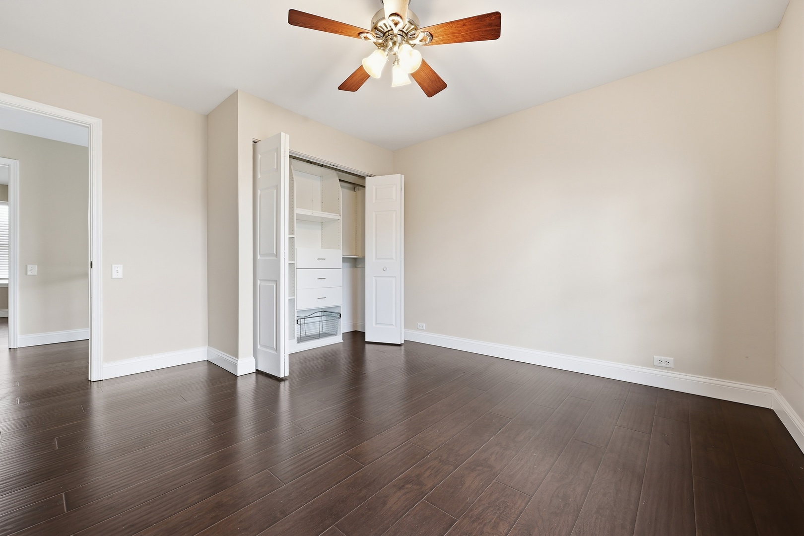 1780 Pebble Beach Circle Elgin, IL 60123 - Photo 16 of 21 an empty room with wooden floor chandelier fan and windows