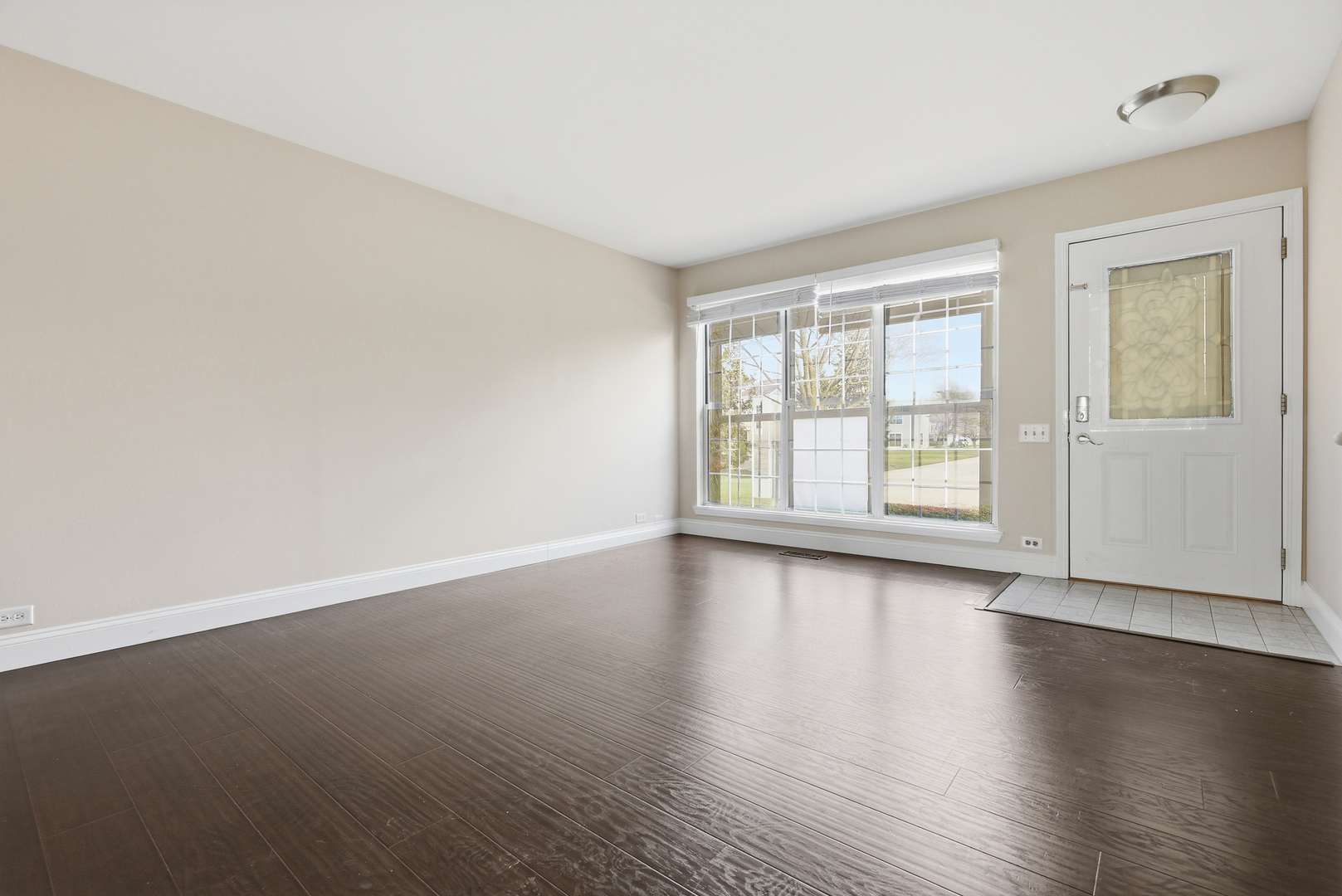 1780 Pebble Beach Circle Elgin, IL 60123 - Photo 2 of 21 an empty room with wooden floor and windows