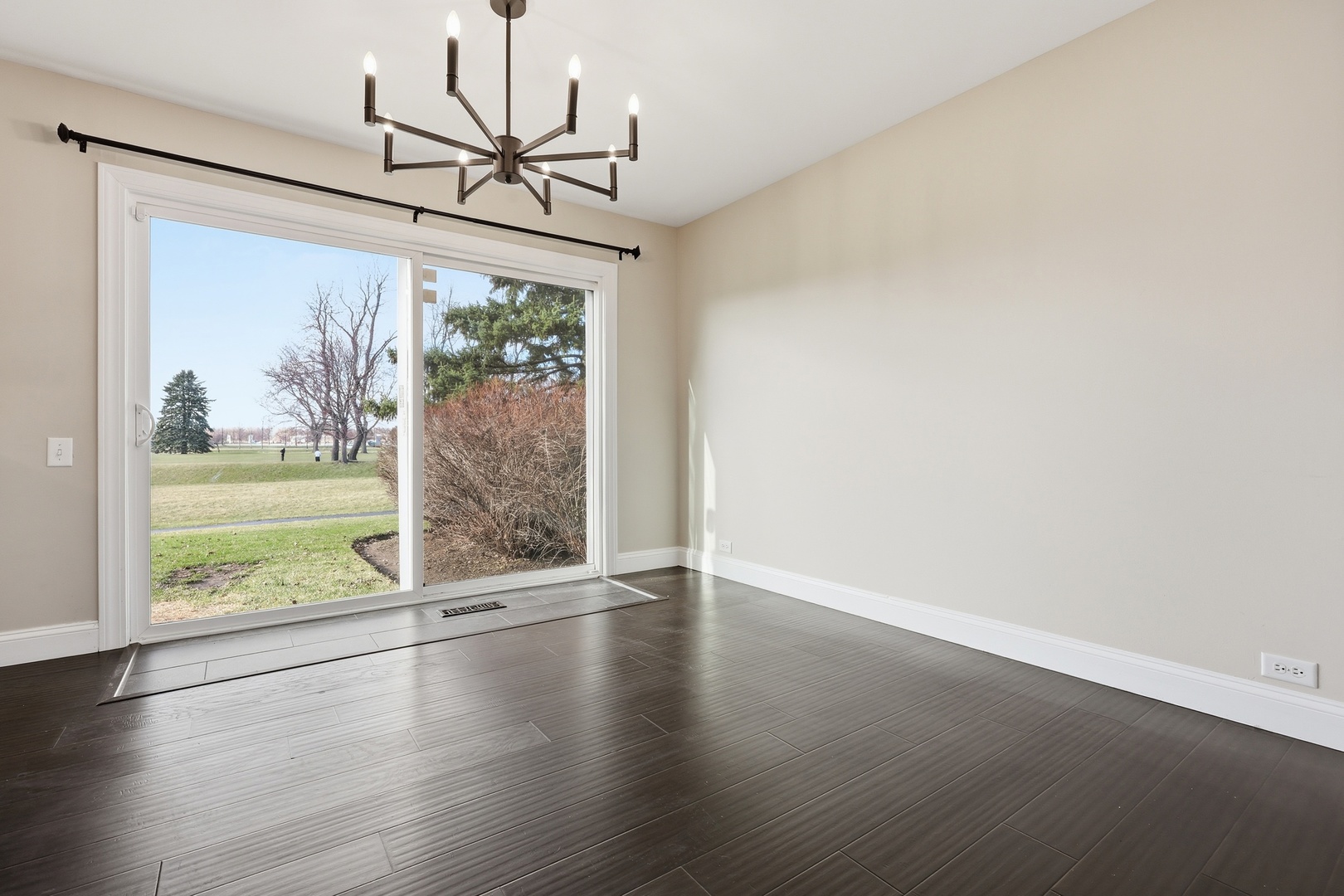 1780 Pebble Beach Circle Elgin, IL 60123 - Photo 5 of 21 an empty room with wooden floor fan and windows