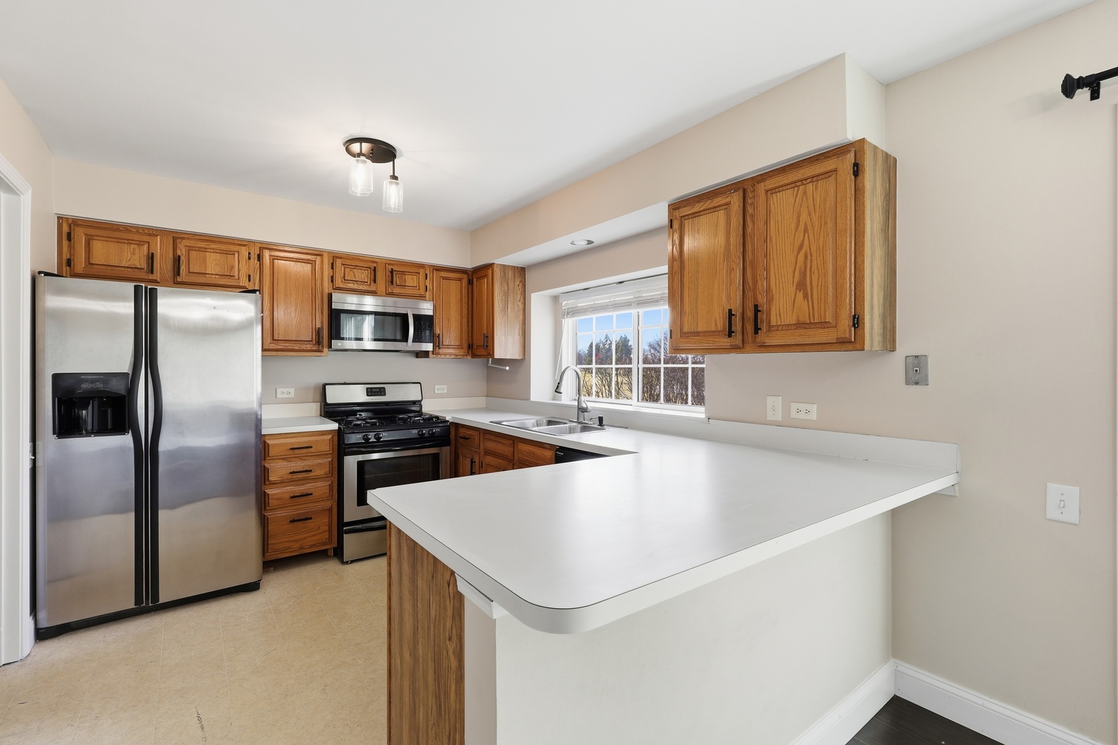 1780 Pebble Beach Circle Elgin, IL 60123 - Photo 6 of 21 a kitchen with stainless steel appliances granite countertop a sink a stove and a refrigerator
