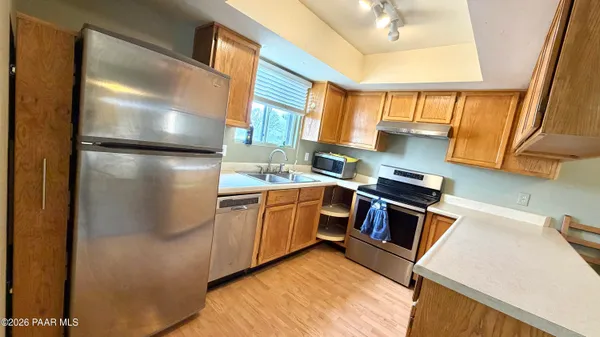 a kitchen with a refrigerator sink and stove