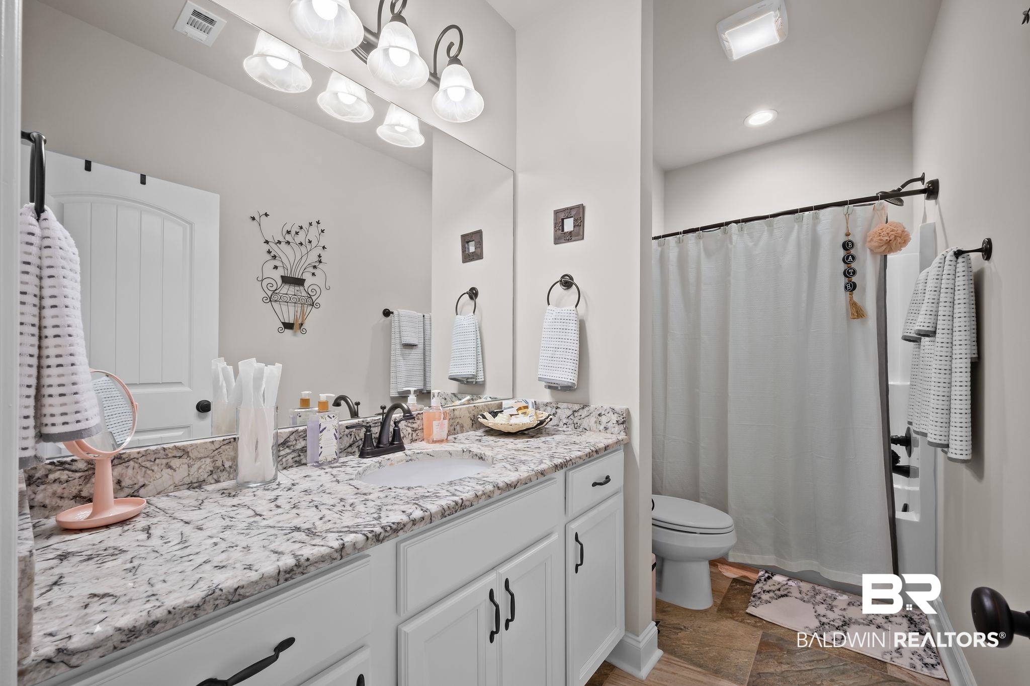 33842 Rutland Lane Spanish Fort, AL 36527 - Photo 31 of 42 Bathroom featuring vanity, visible vents, a shower with curtain, and toilet