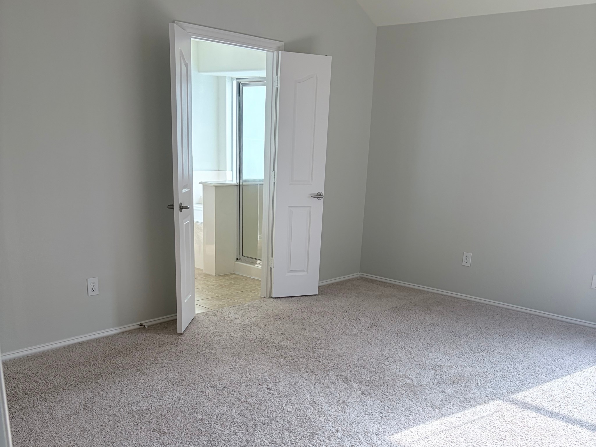 19723 Imperial Colony Lane Katy, TX 77449 - Photo 12 of 16 Alternate angle of the comfortable primary bedroom with direct access to the ensuite bathroom and walk-in closet.