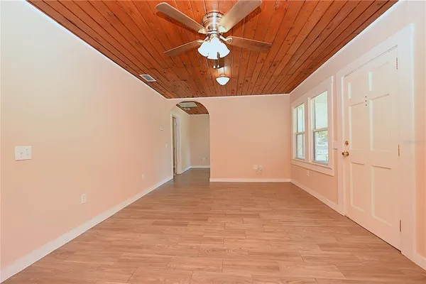 a view of a livingroom with a ceiling fan and window