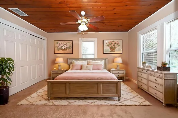 a bedroom with a large bed and a window