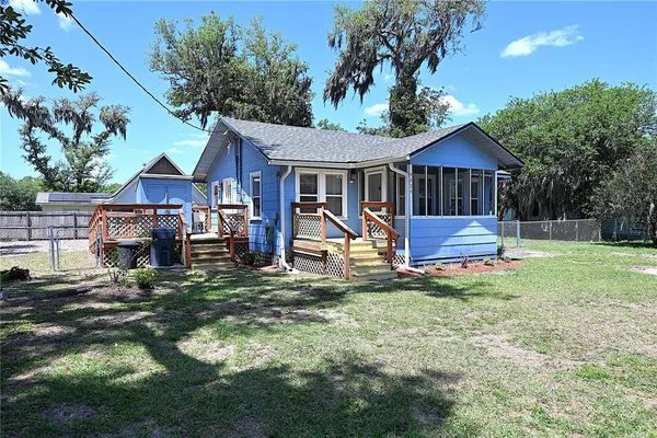 a view of a house with a yard patio and a slide
