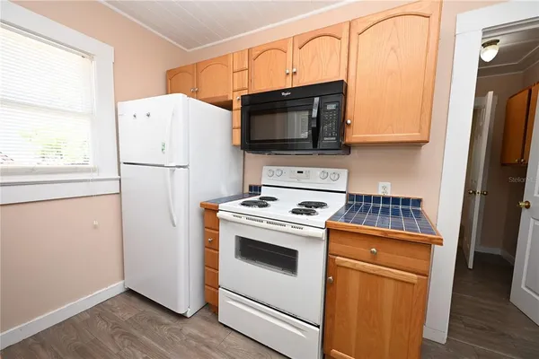 a kitchen with stainless steel appliances a refrigerator stove and microwave