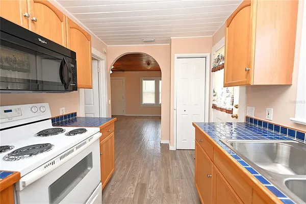 a kitchen with a stove a sink and a microwave