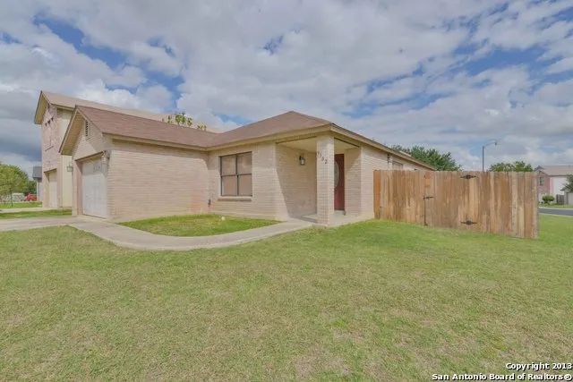 a view of a house with a backyard