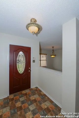 a view of a hallway with a chandelier fan