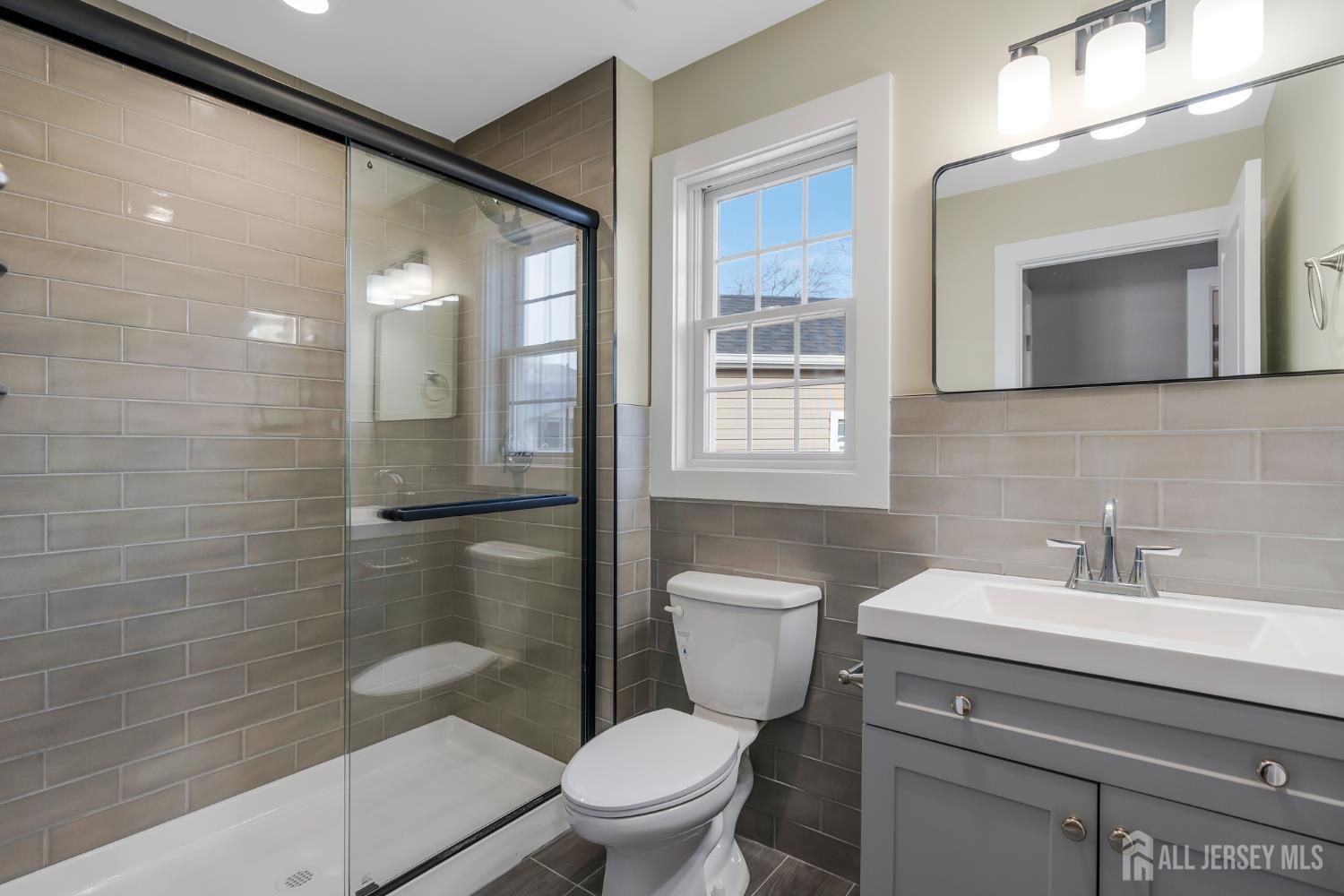 20 Louis Avenue Middlesex, NJ 08846 - Photo 17 of 22 a bathroom with a toilet a sink and mirror