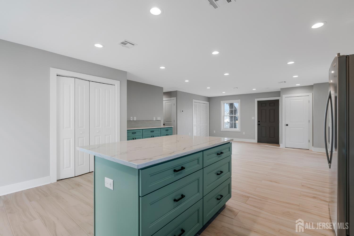20 Louis Avenue Middlesex, NJ 08846 - Photo 5 of 22 a kitchen with kitchen island a sink stainless steel appliances and cabinets